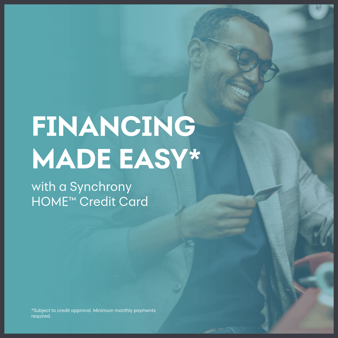 Financing made easy picture of gentleman smiling while holding a credit card making a purchase.